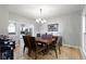 Bright dining room with hardwood floors, chandelier, and view to the kitchen at 18711 Crestline Ct, Noblesville, IN 46060