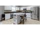 Bright kitchen with white cabinetry, granite countertops, stainless steel appliances, and a center island with barstool seating at 18711 Crestline Ct, Noblesville, IN 46060