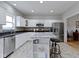 Well-lit kitchen featuring white cabinets, an island with seating, and stainless steel appliances at 18711 Crestline Ct, Noblesville, IN 46060
