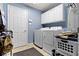 Functional laundry room with white cabinets and appliances at 18711 Crestline Ct, Noblesville, IN 46060