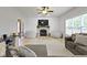 Inviting living room with a fireplace, shiplap wall, cozy furniture, and ample natural light at 18711 Crestline Ct, Noblesville, IN 46060