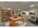 Spacious home office with built-in shelving, carpet and a large wood desk with chair at 18711 Crestline Ct, Noblesville, IN 46060