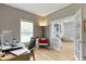 Bright office with French doors leading into the living room and a view of the fireplace at 18711 Crestline Ct, Noblesville, IN 46060