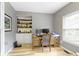 Home office with hardwood floors, built-in shelving, desk, and natural light at 18711 Crestline Ct, Noblesville, IN 46060