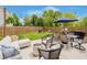 Backyard features a fire pit, patio furniture, a grill, and lush green grass enclosed by a wooden fence at 18760 Pilot Mills Dr, Noblesville, IN 46062