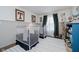Bedroom featuring two white cribs, neutral walls, a striped rug, and decorative touches for a cozy space at 18760 Pilot Mills Dr, Noblesville, IN 46062