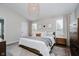 Bright bedroom featuring a neutral color palette, stylish light fixture, and a cozy rug creating a relaxing ambiance at 18760 Pilot Mills Dr, Noblesville, IN 46062