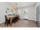 Dining area with black chairs, wood table, and sliding glass door providing natural light and outdoor access at 18760 Pilot Mills Dr, Noblesville, IN 46062