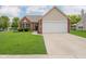 Charming single-story brick home with well-maintained lawn and attached two-car garage at 18760 Pilot Mills Dr, Noblesville, IN 46062