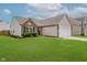 Charming home with brick and siding exterior, a well-manicured lawn, and an attached two-car garage at 18760 Pilot Mills Dr, Noblesville, IN 46062