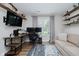 Gaming room with a desk setup, monitor, wall shelves and a cozy couch for relaxation at 18760 Pilot Mills Dr, Noblesville, IN 46062