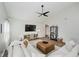 Cozy living room featuring a plush sofa, a leather ottoman, and a media center with decorative accents at 18760 Pilot Mills Dr, Noblesville, IN 46062