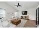 Comfortable living room with vaulted ceilings, modern decor, and entertainment center at 18760 Pilot Mills Dr, Noblesville, IN 46062