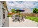 Outdoor patio featuring an umbrella-covered dining table and a comfortable seating area with string lights above at 18760 Pilot Mills Dr, Noblesville, IN 46062