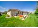 Green backyard featuring a manicured lawn, patio area, landscaping, and serene outdoor enjoyment at 188 Bay Ridge Dr, Pendleton, IN 46064
