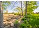 A serene backyard setting with a swing set, fire pit, and green foliage for Gathering fun at 188 Bay Ridge Dr, Pendleton, IN 46064