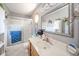 Bright bathroom featuring a large mirror, shower with glass doors, and white tile floor at 188 Bay Ridge Dr, Pendleton, IN 46064