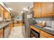 Spacious kitchen featuring oak cabinetry, stainless steel appliances, and adjacent dining area at 188 Bay Ridge Dr, Pendleton, IN 46064