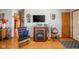 Comfortable living room with a fireplace, TV, wood floors, and stylish decorations at 188 Bay Ridge Dr, Pendleton, IN 46064