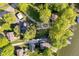 Bird's-eye view showcases the property's lakeside location, mature trees, and private drive at 1940 Stringtown Pike, Cicero, IN 46034
