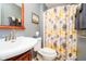 Cozy bathroom featuring a floral shower curtain, sink, and toilet at 1940 Stringtown Pike, Cicero, IN 46034