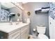 Charming bathroom with blue accents, decorative mirror, and convenient towel rack at 1940 Stringtown Pike, Cicero, IN 46034