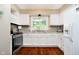 Well-lit kitchen featuring white cabinets, stainless steel appliances, and granite countertops at 1940 Stringtown Pike, Cicero, IN 46034