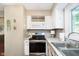 Kitchen with white cabinets, stainless steel appliances, and a stainless steel sink at 1940 Stringtown Pike, Cicero, IN 46034