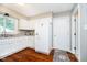 Bright kitchen with white cabinets, granite countertops, stainless steel sink, and hardwood floors at 1940 Stringtown Pike, Cicero, IN 46034