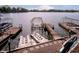 Lakefront view of multiple boat docks and boat lift, providing direct access to the water for boating and recreation at 1940 Stringtown Pike, Cicero, IN 46034