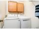 Laundry room featuring a washer, dryer, and cabinet at 1940 Stringtown Pike, Cicero, IN 46034