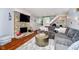 Cozy living room with a stone fireplace, hardwood floors, and a comfortable gray sectional sofa at 1940 Stringtown Pike, Cicero, IN 46034