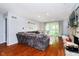 Spacious living room with hardwood floors, a comfortable sofa, and sliding glass doors leading to the backyard at 1940 Stringtown Pike, Cicero, IN 46034
