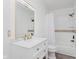 Bright bathroom featuring white vanity, gold fixtures, and shower and tub combo at 2302 S Pennsylvania St, Indianapolis, IN 46225