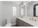 Bathroom featuring double sink vanity, gold fixtures, and modern lighting at 2302 S Pennsylvania St, Indianapolis, IN 46225