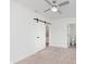 The bedroom offers white walls and trim plus a ceiling fan at 2302 S Pennsylvania St, Indianapolis, IN 46225