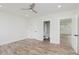 Large, bright bedroom with new flooring, ceiling fan, and access to an en-suite bathroom at 2302 S Pennsylvania St, Indianapolis, IN 46225