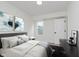 Comfortable bedroom features a plush bed, modern artwork, and lots of natural light at 2302 S Pennsylvania St, Indianapolis, IN 46225