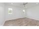 Bright, spacious bedroom with new flooring, ceiling fan, and ample natural light at 2302 S Pennsylvania St, Indianapolis, IN 46225