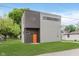 A modern two-story home featuring a grey exterior and bright orange front door at 2302 S Pennsylvania St, Indianapolis, IN 46225