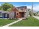 Beautiful two-story home with a modern design, a mix of wood, grey, and black finishes, a deck, and a well-kept lawn at 2302 S Pennsylvania St, Indianapolis, IN 46225