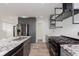 Modern kitchen with granite countertops, gray cabinetry, stainless steel appliances and luxury vinyl plank flooring at 2302 S Pennsylvania St, Indianapolis, IN 46225