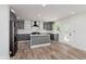 Bright, modern kitchen with gray cabinets, granite countertops, stainless steel appliances, and wood-look flooring at 2302 S Pennsylvania St, Indianapolis, IN 46225