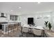 Bright open kitchen with stainless steel appliances, gray cabinetry, and a marble countertop island at 2302 S Pennsylvania St, Indianapolis, IN 46225