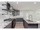 Bright, updated kitchen featuring stainless appliances, gray cabinets, and granite countertops at 2302 S Pennsylvania St, Indianapolis, IN 46225