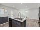 A modern kitchen with granite countertops, stainless steel appliances, and light gray wood look flooring at 2302 S Pennsylvania St, Indianapolis, IN 46225