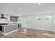 Spacious kitchen featuring grey cabinets, modern appliances, an island, and wood-look floors at 2302 S Pennsylvania St, Indianapolis, IN 46225