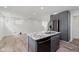 Updated kitchen island features granite countertop, sink, dishwasher, and sleek, dark grey cabinets at 2302 S Pennsylvania St, Indianapolis, IN 46225