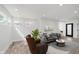 A stylish living room featuring a modern brown chair, a grey couch, hardwood floors, and ample natural light at 2302 S Pennsylvania St, Indianapolis, IN 46225