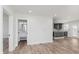 An open space with light wood floors connecting the kitchen and a well-lit bathroom at 2302 S Pennsylvania St, Indianapolis, IN 46225